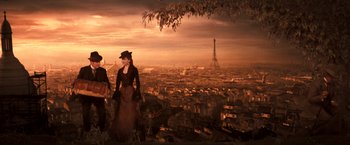 Movie still from “Moulin Rouge!” (2001), directed by Baz Luhrmann – A woman in a dress and hat standing on a hill; Wide shot, Low angle