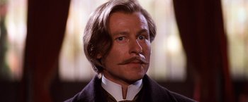 Movie still from “Moulin Rouge!” (2001), directed by Baz Luhrmann – A person with a mustache; Close Up shot, Low angle