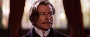 Movie still from “Moulin Rouge!” (2001), directed by Baz Luhrmann – A person with a mustache; Close Up shot, Low angle