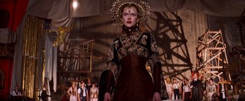 Movie still from “Moulin Rouge!” (2001), directed by Baz Luhrmann – A woman in a brown dress and a gold headpiece; Medium shot, Low angle