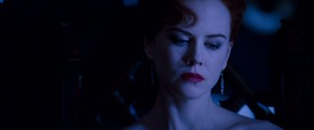 Movie still from “Moulin Rouge!” (2001), directed by Baz Luhrmann – A person wearing a dress; Close Up shot, Low angle