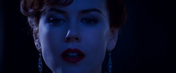 Movie still from “Moulin Rouge!” (2001), directed by Baz Luhrmann – A person wearing a red lipstick; Close Up shot, Over the shoulder angle