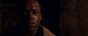 Movie still from “Moulin Rouge!” (2001), directed by Baz Luhrmann – A man's face in the dark; Close Up shot, Low angle