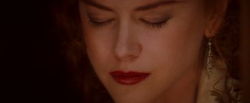 Movie still from “Moulin Rouge!” (2001), directed by Baz Luhrmann – A woman's face with red lipstick; Extreme Close Up shot, Overhead angle