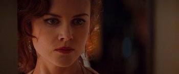 Movie still from “Moulin Rouge!” (2001), directed by Baz Luhrmann – A young woman's face in the dark; Close Up shot, Over the shoulder angle