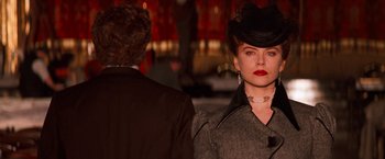 Movie still from “Moulin Rouge!” (2001), directed by Baz Luhrmann – A woman wearing a hat and a coat; Medium shot, Over the shoulder angle