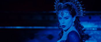 Movie still from “Moulin Rouge!” (2001), directed by Baz Luhrmann – A woman in a blue dress with a crown on her head; Close Up shot, Over the shoulder angle