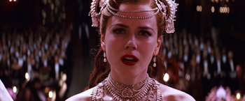 Movie still from “Moulin Rouge!” (2001), directed by Baz Luhrmann – A person wearing a necklace and earrings; Close Up shot, Over the shoulder angle
