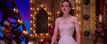 Movie still from “Moulin Rouge!” (2001), directed by Baz Luhrmann – A woman in a white dress and a necklace; Medium shot, Over the shoulder angle