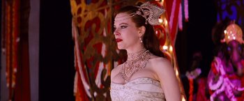 Movie still from “Moulin Rouge!” (2001), directed by Baz Luhrmann – A woman in a white dress with a necklace and earrings; Medium shot, Over the shoulder angle