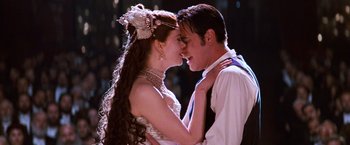 Movie still from “Moulin Rouge!” (2001), directed by Baz Luhrmann – A man and a woman are kissing each other; Close Up shot, Low angle