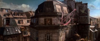 Movie still from “Moulin Rouge!” (2001), directed by Baz Luhrmann – An old building with a lot of graffiti on it's roof; Extreme Wide shot, High angle