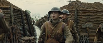 Movie still from “1917” (2019), directed by Sam Mendes – Two men in military uniforms walking down a dirt path; Medium shot, Low angle