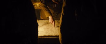 Movie still from “1917” (2019), directed by Sam Mendes – A man pointing to a map on the floor; Medium shot, High angle