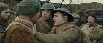 Movie still from “1917” (2019), directed by Sam Mendes – Three men in military uniforms and hats are talking; Close Up shot, Over the shoulder angle