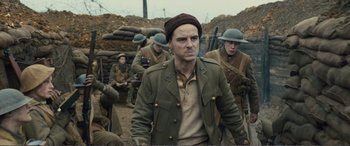 Movie still from “1917” (2019), directed by Sam Mendes – A group of men in military uniforms in a field; Medium shot, Over the shoulder angle