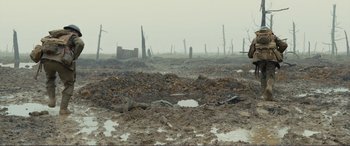 Movie still from “1917” (2019), directed by Sam Mendes – A field that has a lot of dirt on the ground; Extreme Wide shot, High angle