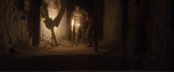 Movie still from “1917” (2019), directed by Sam Mendes – A group of men standing next to each other in the dark; Wide shot, High angle