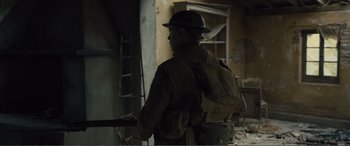 Movie still from “1917” (2019), directed by Sam Mendes – A man wearing a hat and a backpack; Medium shot, Low angle