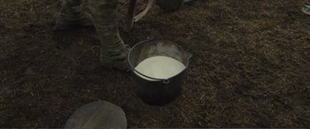 Movie still from “1917” (2019), directed by Sam Mendes – A bucket full of milk sitting on the ground; Extreme Close Up shot, High angle