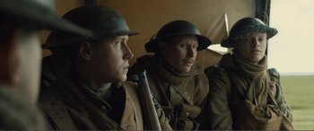 Movie still from “1917” (2019), directed by Sam Mendes – A couple of men in military uniforms with guns; Medium shot, Low angle