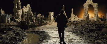 Movie still from “1917” (2019), directed by Sam Mendes – A person is walking down a path at night; Wide shot, Low angle