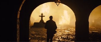 Movie still from “1917” (2019), directed by Sam Mendes – A man standing in front of a cross in a tunnel; Extreme Wide shot, Low angle