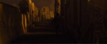 Movie still from “1917” (2019), directed by Sam Mendes – A person walking down a dark alley at night; Extreme Wide shot, Low angle