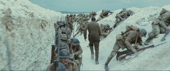Movie still from “1917” (2019), directed by Sam Mendes – A group of men in world war i uniforms on a snowy hill; Extreme Wide shot, High angle