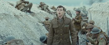 Movie still from “1917” (2019), directed by Sam Mendes – A group of men standing next to each other on top of a hill; Medium shot, Low angle