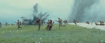 Movie still from “1917” (2019), directed by Sam Mendes – A group of men are running through a field; Extreme Wide shot, High angle