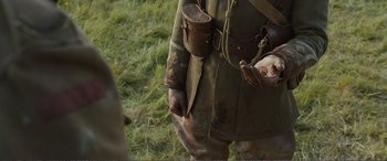 Movie still from “1917” (2019), directed by Sam Mendes – An old man in a military uniform holding a gun; Close Up shot, High angle
