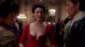 Movie still from “Outlander” (2014), created by Ronald D. Moore – A woman in a red dress; Medium shot, Over the shoulder angle