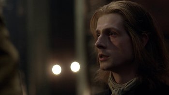 Movie still from “Outlander” (2014), created by Ronald D. Moore – A person with long blonde hair; Close Up shot, Over the shoulder angle