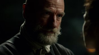 Movie still from “Outlander” (2014), created by Ronald D. Moore – An old man with a beard and a white mustache; Close Up shot, Over the shoulder angle