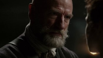 Movie still from “Outlander” (2014), created by Ronald D. Moore – An old man with a beard and a white mustache; Close Up shot, Over the shoulder angle
