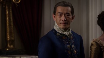 Movie still from “Outlander” (2014), created by Ronald D. Moore – A man in a blue jacket with flowers on it; Close Up shot, Over the shoulder angle