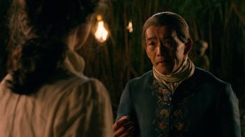 Movie still from “Outlander” (2014), created by Ronald D. Moore – An older man talking to a younger woman; Close Up shot, Over the shoulder angle