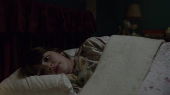 Movie still from “Outlander” (2014), created by Ronald D. Moore – A young girl laying in bed with a cat; Close Up shot, High angle
