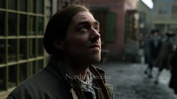 Movie still from “Outlander” (2014), created by Ronald D. Moore – A person wearing a coat; Close Up shot, Over the shoulder angle