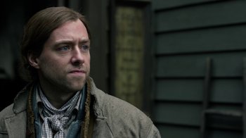 Movie still from “Outlander” (2014), created by Ronald D. Moore – A person wearing a jacket; Close Up shot, Over the shoulder angle