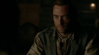 Movie still from “Outlander” (2014), created by Ronald D. Moore – A person wearing a shirt and vest; Close Up shot, Over the shoulder angle