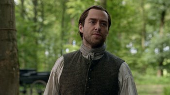 Movie still from “Outlander” (2014), created by Ronald D. Moore – A person wearing a vest; Close Up shot, Over the shoulder angle