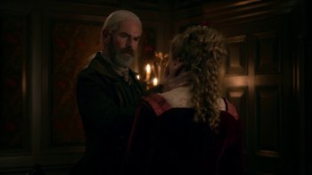 Movie still from “Outlander” (2014), created by Ronald D. Moore – A man and a woman are standing in front of a fireplace; Close Up shot, Over the shoulder angle