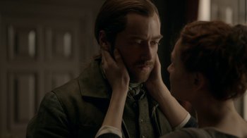 Movie still from “Outlander” (2014), created by Ronald D. Moore – A man with long hair is touching his face; Close Up shot, Over the shoulder angle