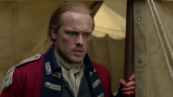 Movie still from “Outlander” (2014), created by Ronald D. Moore – A person holding an umbrella; Close Up shot, Over the shoulder angle