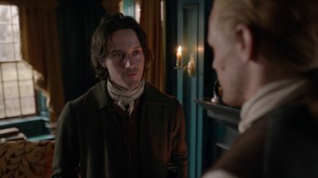 Movie still from “Outlander” (2014), created by Ronald D. Moore – A man in a brown jacket standing next to another man in a brown jacket; Close Up shot, Over the shoulder angle