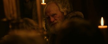 Movie still from “Outlaw King” (2018), directed by David Mackenzie – An old man with long white hair and a beard; Close Up shot, Over the shoulder angle