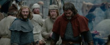 Movie still from “Outlaw King” (2018), directed by David Mackenzie – A group of men dressed in medieval clothing; Medium shot, Low angle