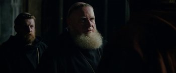 Movie still from “Outlaw King” (2018), directed by David Mackenzie – An old man with a beard and a mustache is looking at the camera; Close Up shot, Over the shoulder angle